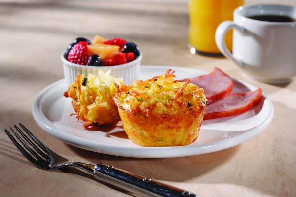 Hashbrown Muffin with a Side of Fruit on a Plate